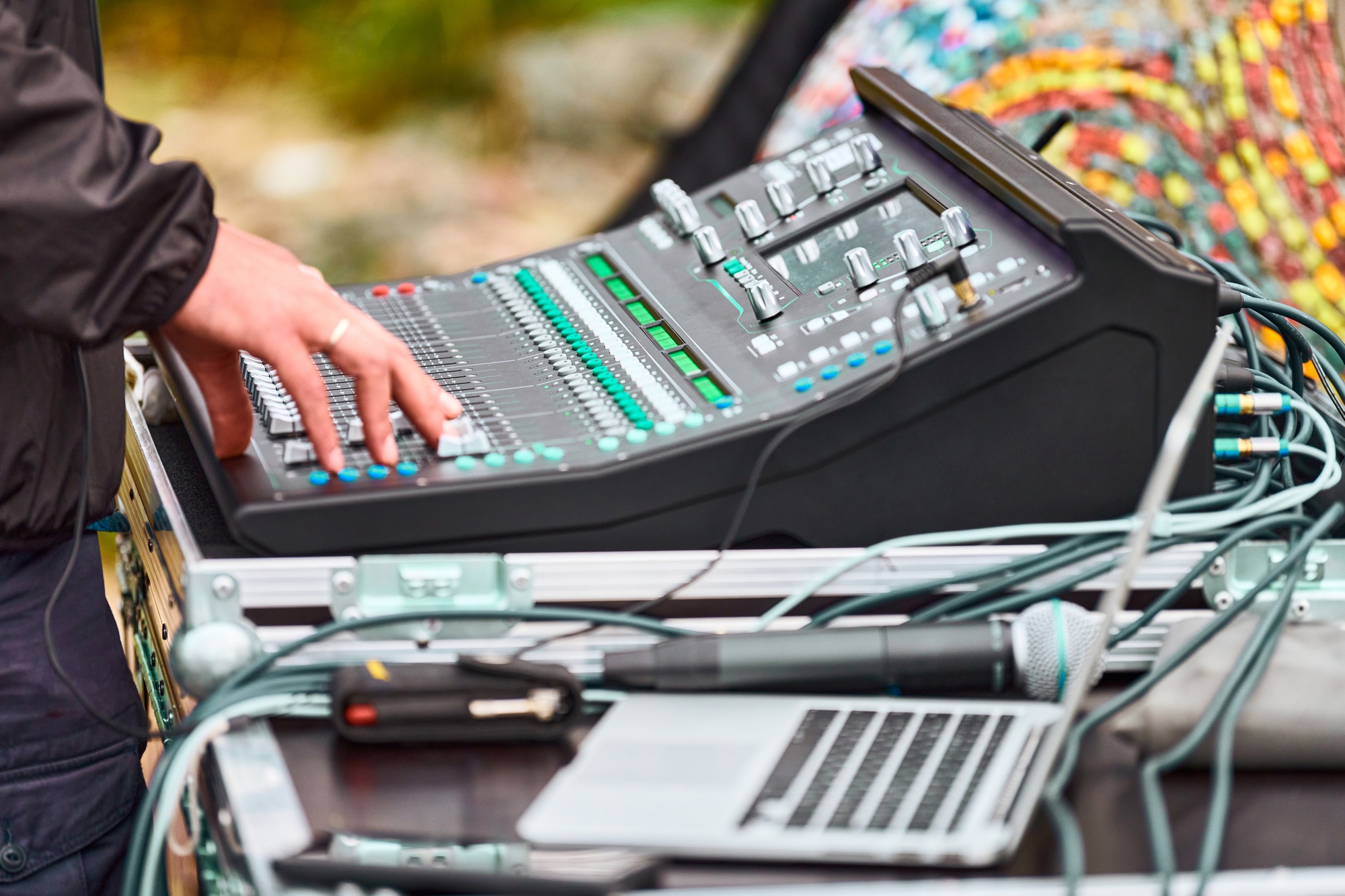 Sound engineer hands working on sound mixer at live concert, stage sound mixer, audio mix slider